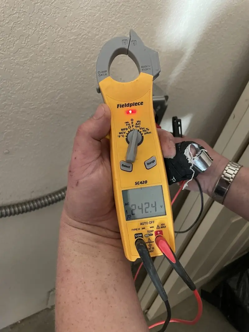 Voltage testing with clamp meter during Outlet Installation in Marshfield